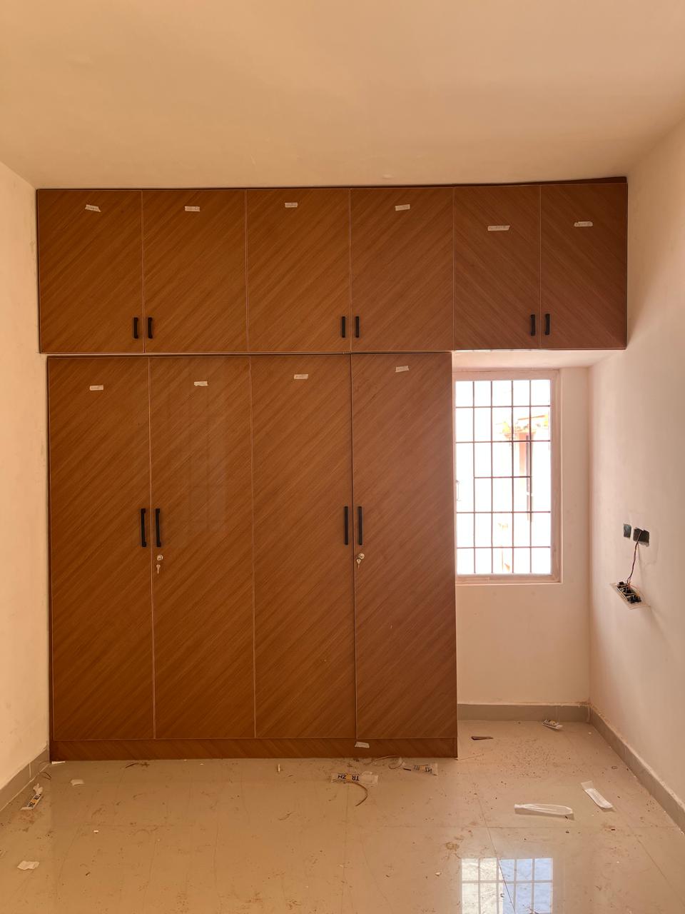 Full height wooden wardrobe with overhead loft storage