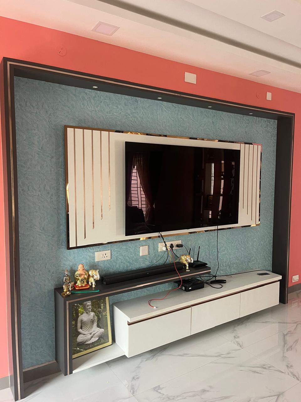 Living room media wall with textured panel and floating white console