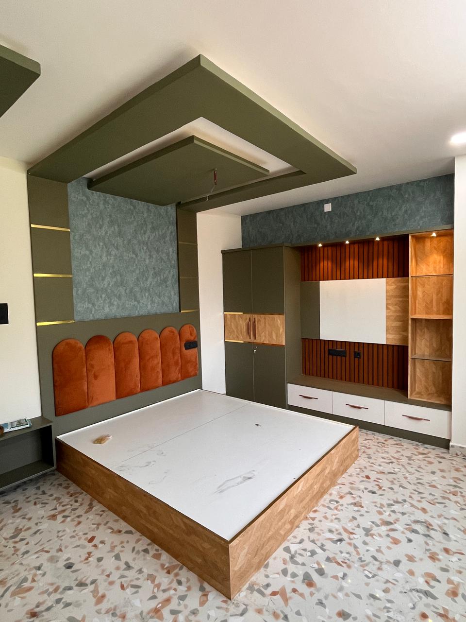 Bedroom with arched upholstered headboard, false ceiling and fitted storage
